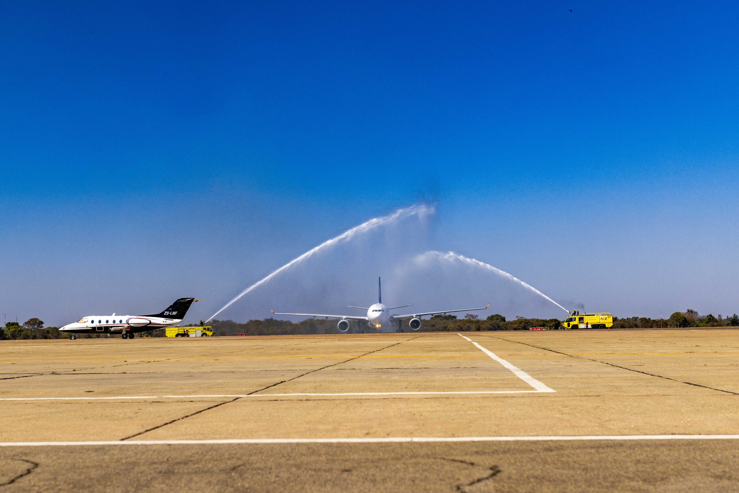 Air Zimbabwe aircraft passing through a water salute on the apron